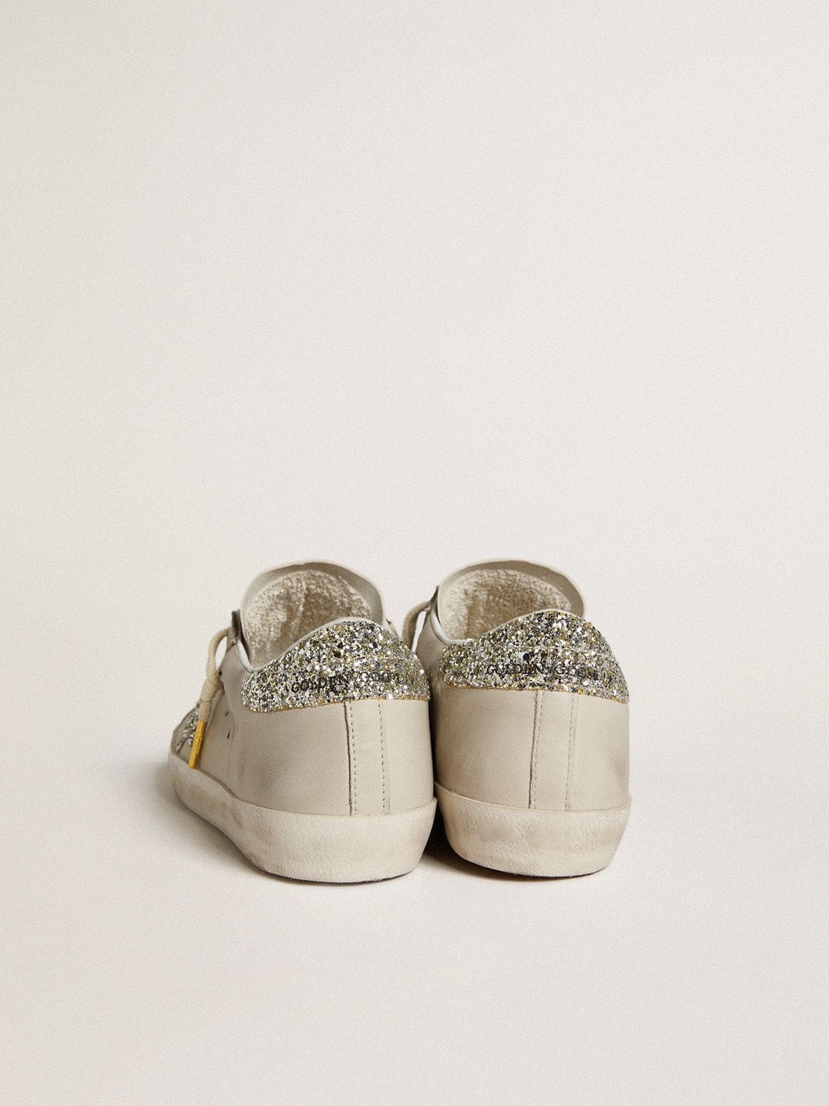 LTD in ivory nappa leather with platinum glitter star and heel tab