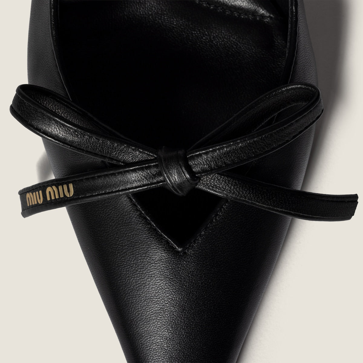Black leather slingback pumps with bow