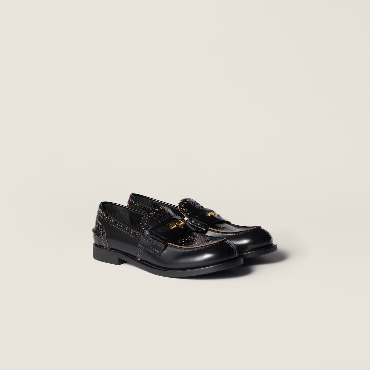 Black leather loafers with gold coin detail