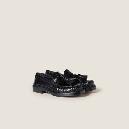 Brushed leather loafers with black tassels