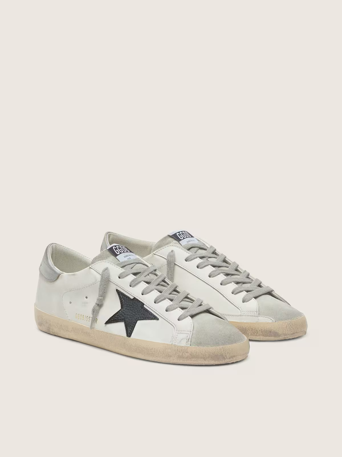 White leather with black nubuck leather star and silver laminated leather heel tab