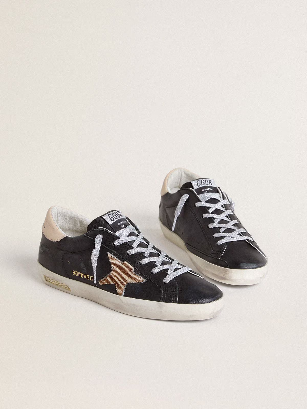 Black nappa leather with zebra-print pony skin star and beige leather heel tab
