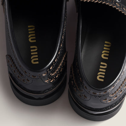 Black leather loafers with gold coin detail
