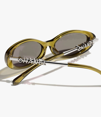 Occhiali da sole ovali in acetato e metallo color oliva con lenti marrone scuro