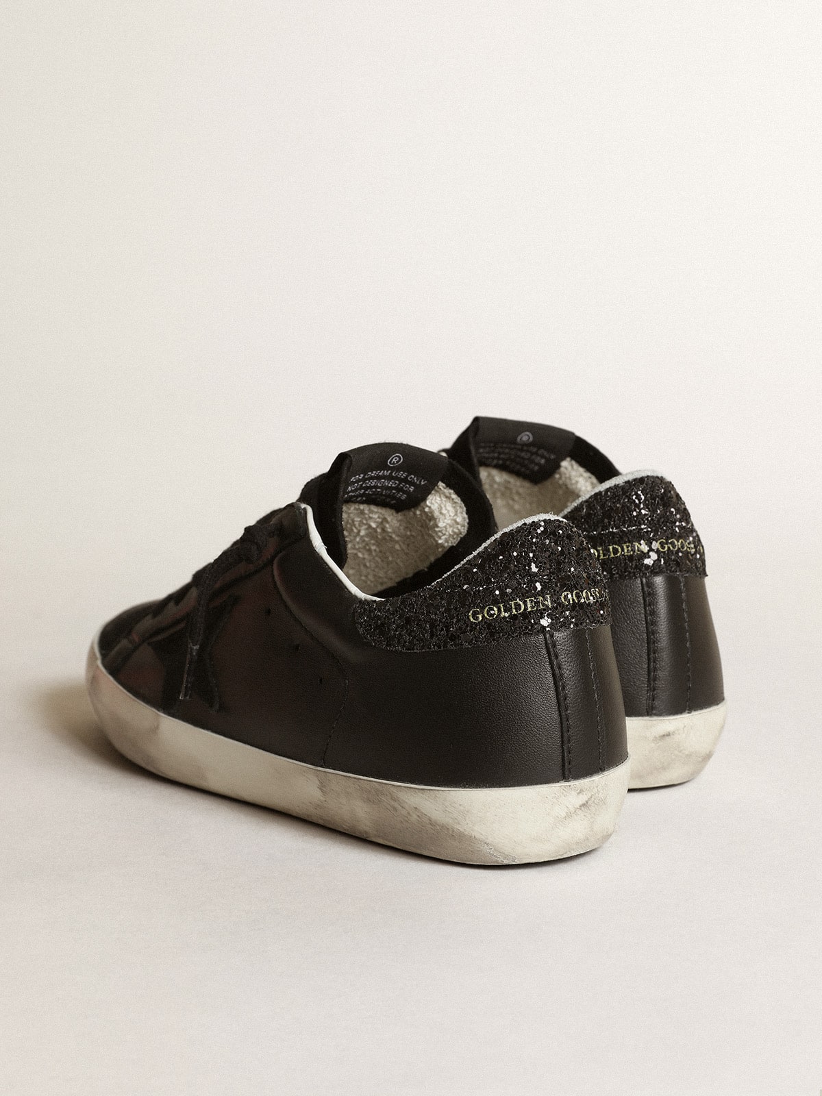 Nappa nera con stella in suede nero e talloncino in glitter neri