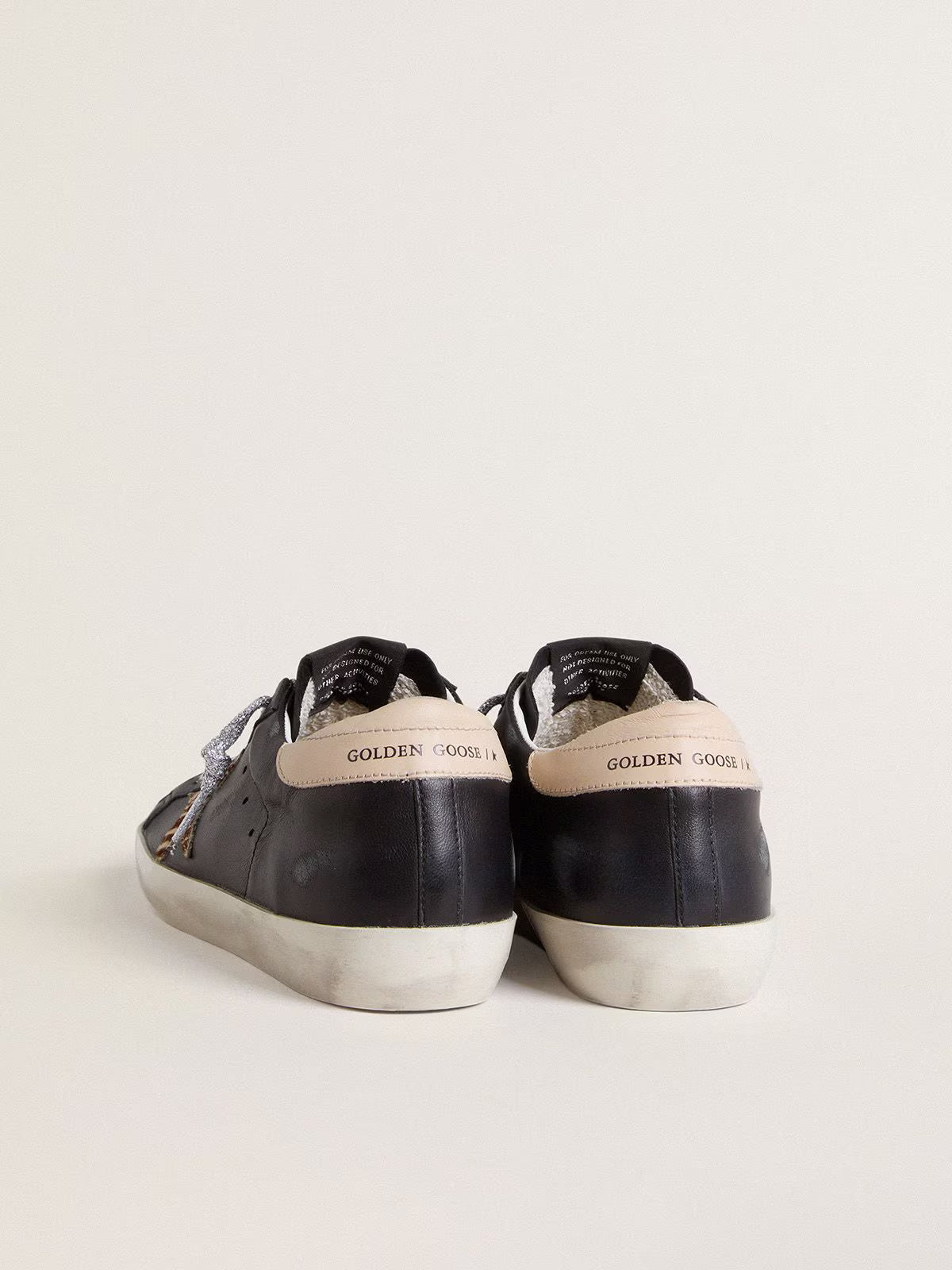 Black nappa leather with zebra-print pony skin star and beige leather heel tab