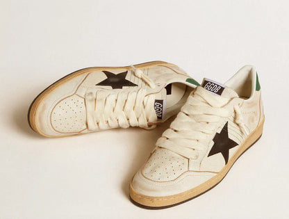 Stella in pelle nera e talloncino in pelle verde